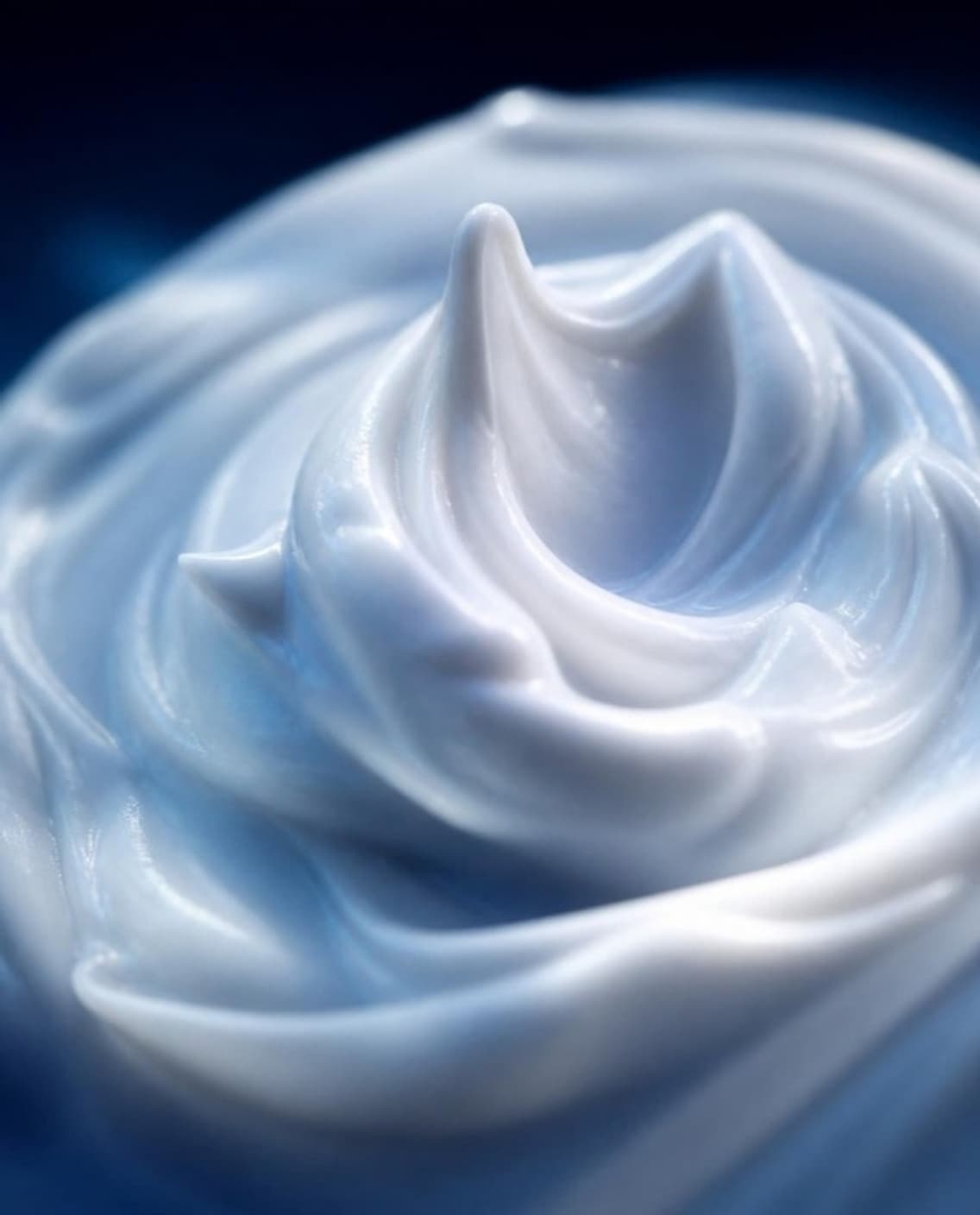 A thick whipped cream swirl in cool blue light.